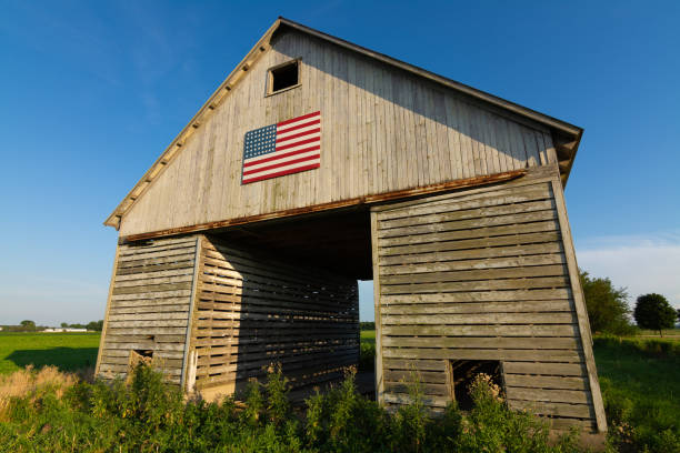 istock Old wooden barn with American Flag 1162257109