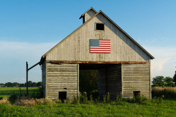 istock Old wooden barn with American Flag 1162257141