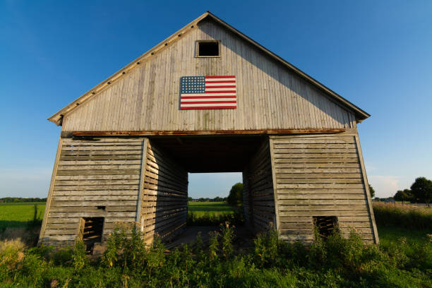 istock Old wooden barn with American Flag 1162257686