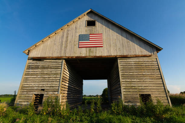 istock Old wooden barn with American Flag 1162257759