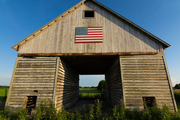 istock Old wooden barn with American Flag 1162257880