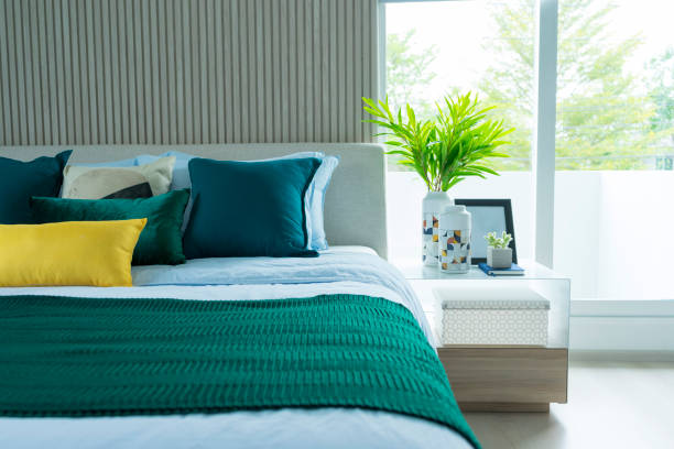 istock modern bedroom interior with green and yellow pillow on it. 1162260656