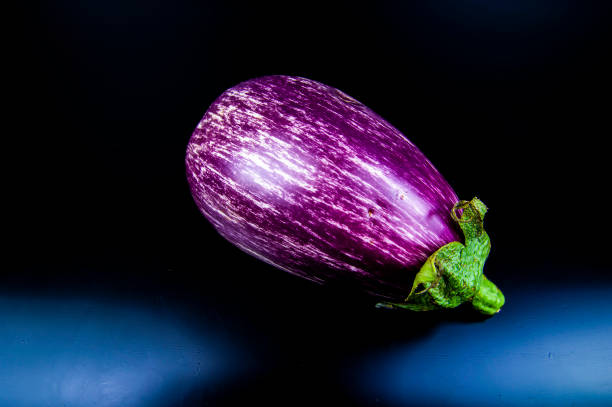 istock Garden vegetable eggplant on a black background. 1162264466