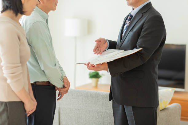 istock Businessman explaining to middle aged couple 1162265358