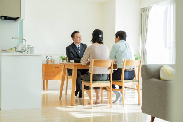 istock Businessman explaining to middle aged couple 1162265361