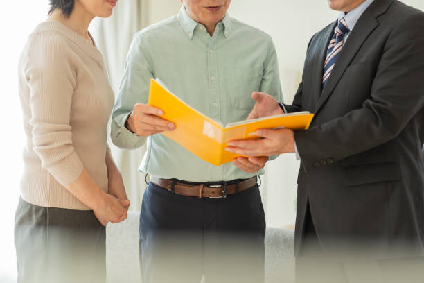 istock Businessman explaining to middle aged couple 1162265366