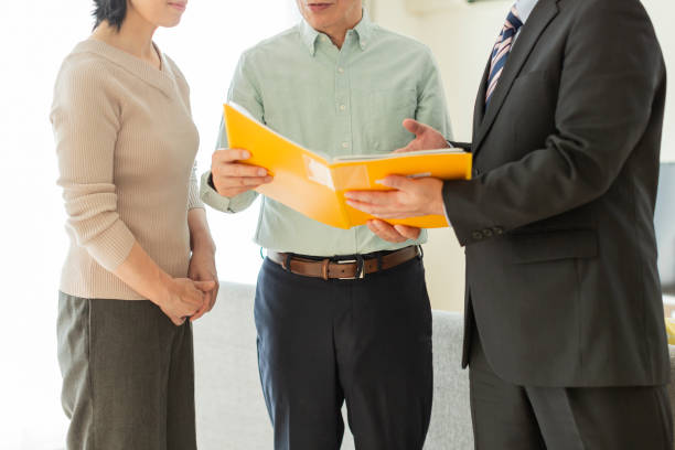 istock Businessman explaining to middle aged couple 1162265367