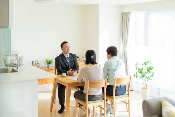istock Businessman explaining to middle aged couple 1162265383