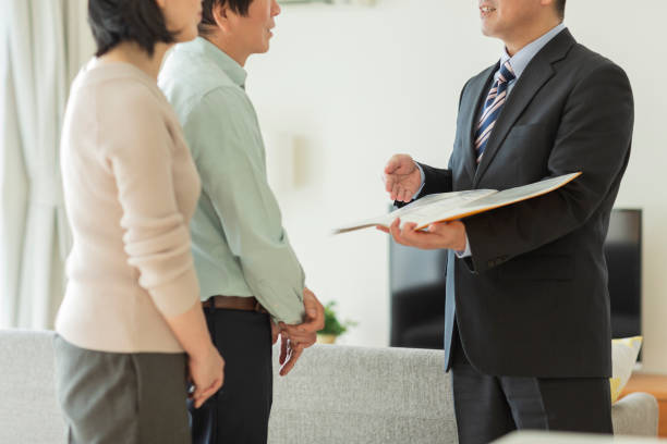 Businessman explaining to middle aged couple