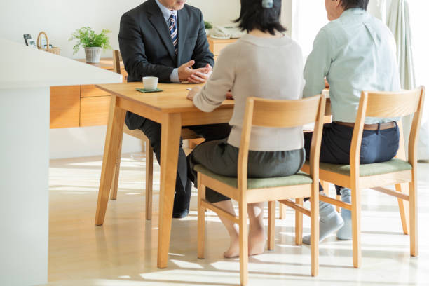 istock Businessman explaining to middle aged couple 1162265388