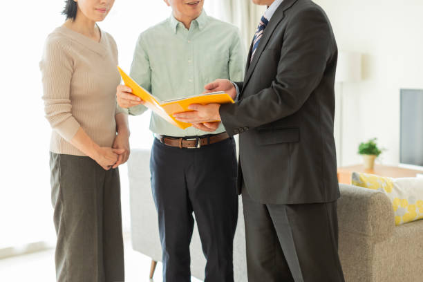 istock Businessman explaining to middle aged couple 1162265390