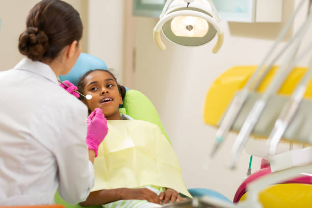 istock Female dentist in aseptic gloves holding dentists tools 1162266289