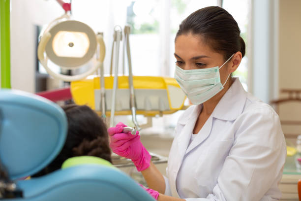 istock Serious doctor looking at a young female patient 1162266293
