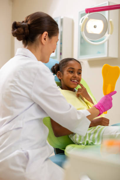 istock Pretty young female patient looking in the mirror 1162266306