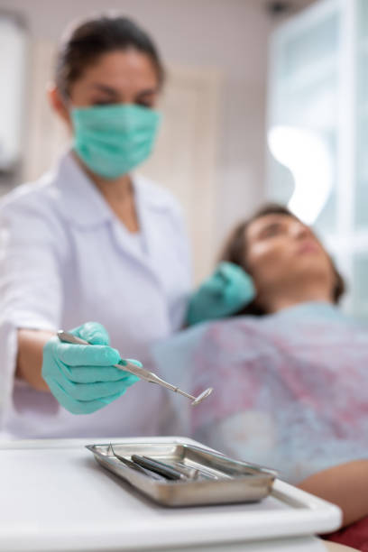 istock Caucasian female doctors hands holding a mouth mirror 1162266335