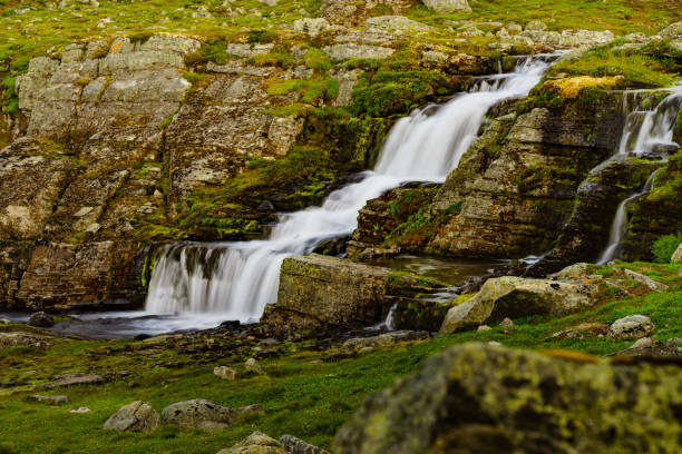 istock Little waterfall in mountains, Norway. 1162269539