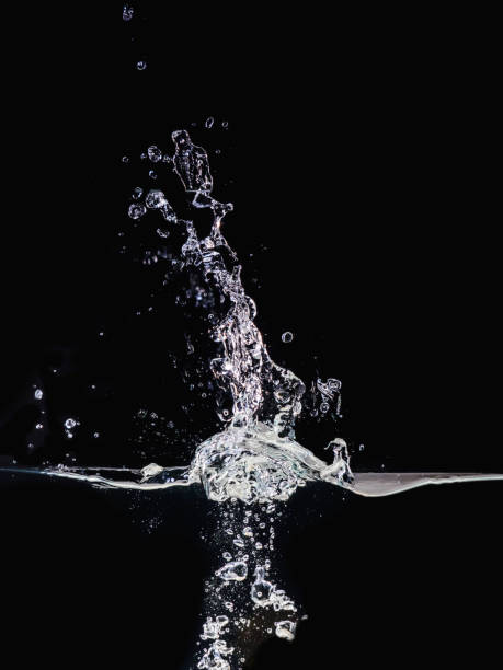 istock Water splash on surface isolated on black background, close up view. Small water bubbles underwater and in air. Abstract background for overlays design, screen blending mode layer. 1162270453