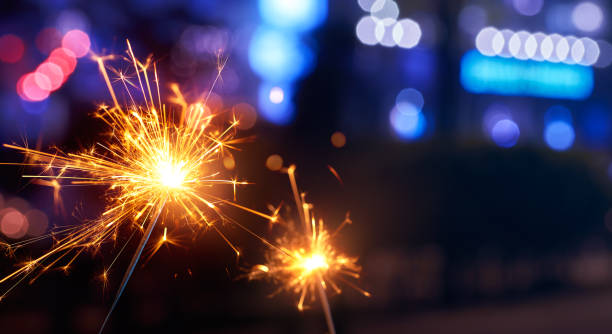 istock Sparkler with blurred street light background 1162271563