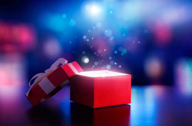istock Red open gift box with magical light against blurred bokeh light background 1162271564