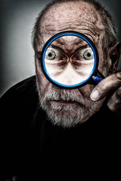 istock Spooky Mirrored Eyes Senior Man Staring Through Magnifying Glass 1162271694