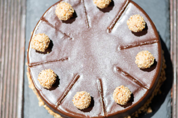 istock Chocolate cake on a wooden table with nuts. Top view. 1162272530