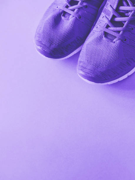 istock Purple trainers on monochrome background. 1162273965