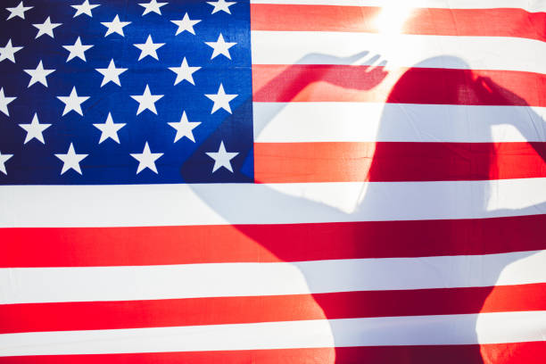 istock Female silhouette behind USA flag 1162276430