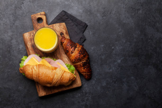 istock Fresh orange juice and croissant sandwich 1162278335