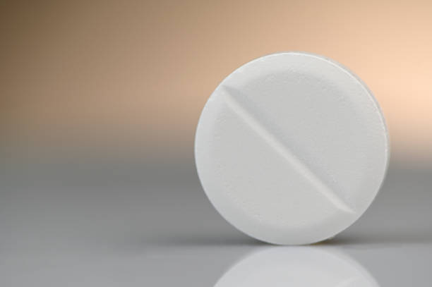 istock White pill aspirin rotate on a black background, Macro shot 1162278470
