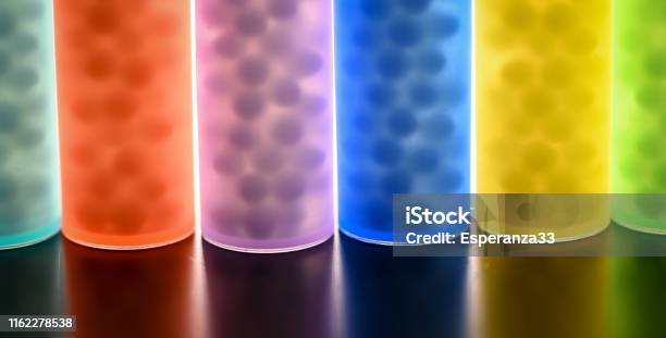 Modern Color Homeopathic Pills In Plastic Container On Black Background France Stock Photo - Download Image Now