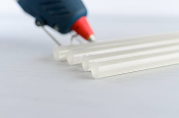 blue glue gun and hot melt rods on white background - handgun gun blue black imagens e fotografias de stock