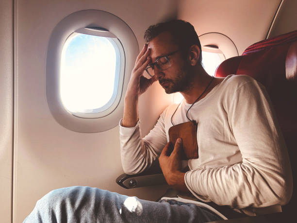 istock Airplane passenger with a neck bag for safe carrying money and documents. 1162282336