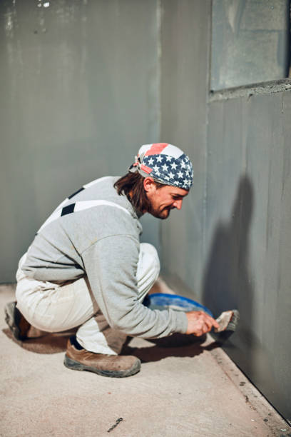 istock Painter painting walls with a paint brush. 1162282936