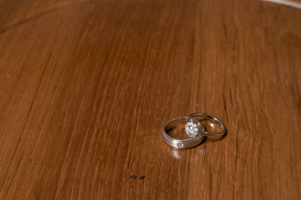 istock Beautiful wedding ring on brown wooden table 1162283088