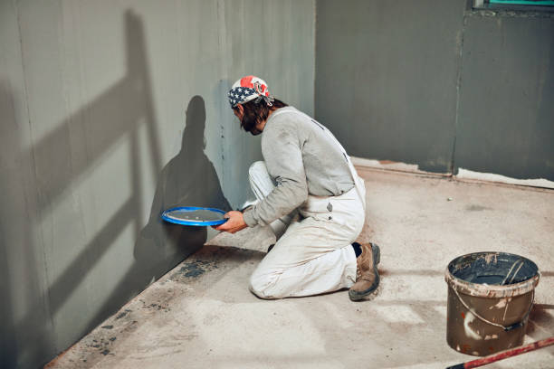 istock Painter painting walls with a paint brush. 1162283242