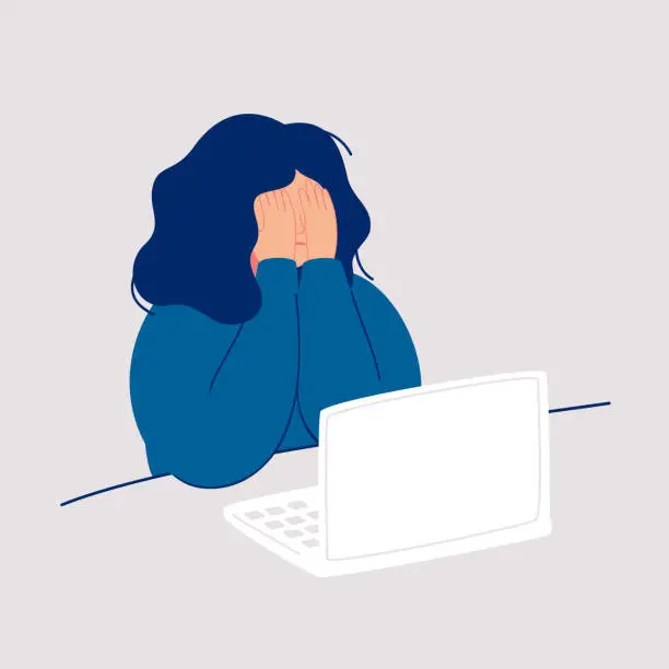 Vector illustration of Disheveled woman sits at the computer and crying covering her face with her hands.
