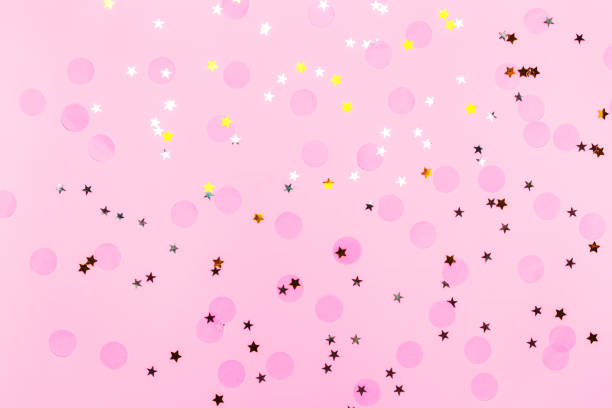 istock Pink confetti and stars and sparkles on pink background. 1162285343