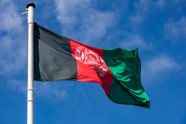 istock Afghanistan flag waving against clear blue sky 1162285765