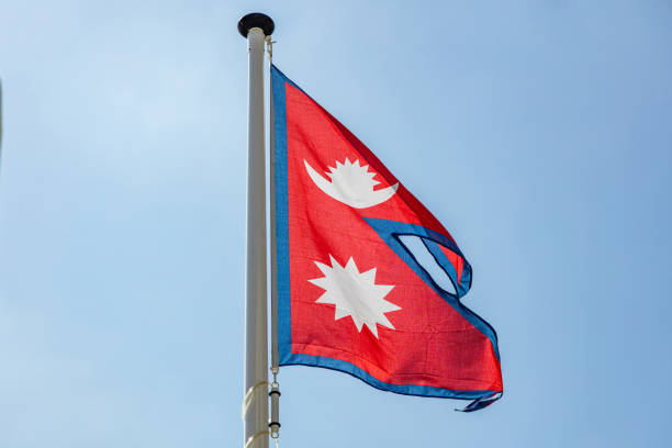 istock Nepal flag waving against clear blue sky 1162285806