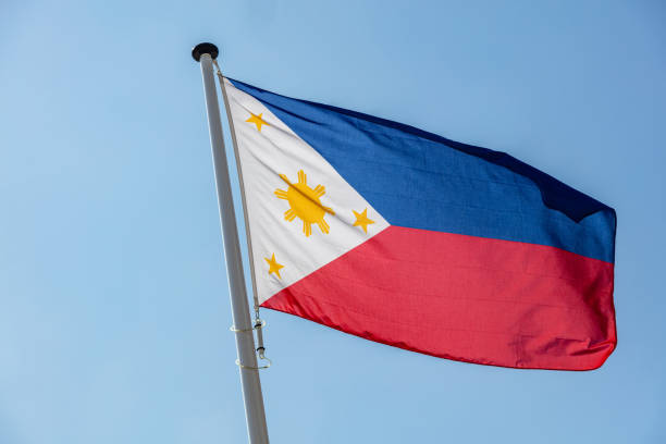 istock Philippines flag waving against clear blue sky 1162285817