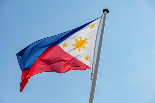 istock Philippines flag waving against clear blue sky 1162285824