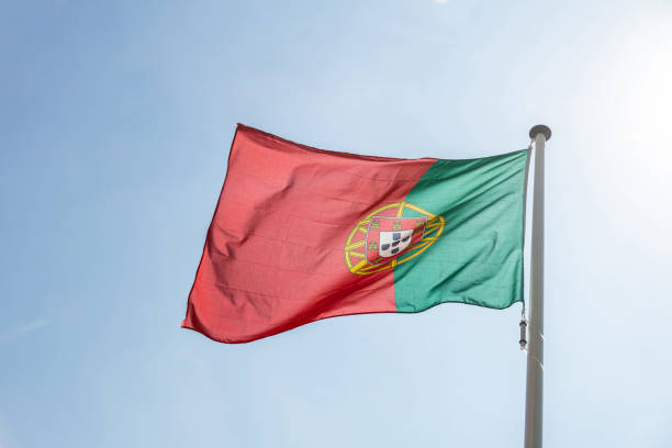 istock Portugal flag waving against clear blue sky 1162285828
