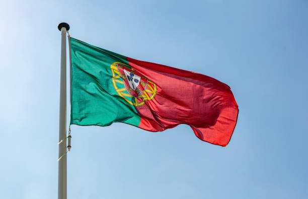 istock Portugal flag waving against clear blue sky 1162285829