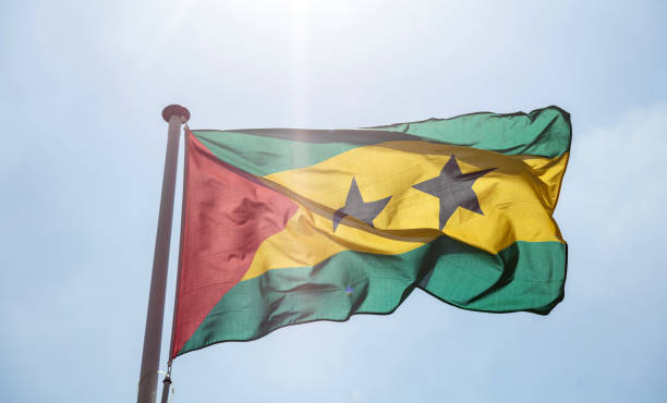 istock Saint Thomas and Prince Islands flag waving against clear blue sky 1162285835