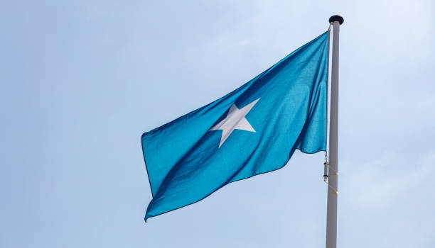 istock Somalia flag waving against clear blue sky 1162285849