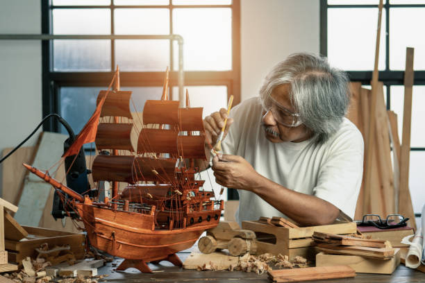 istock asian senior carpenter concentrating to his woodwork in workshop as hobby 1162285923