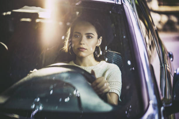 istock Beautiful woman driving a car. 1162286588