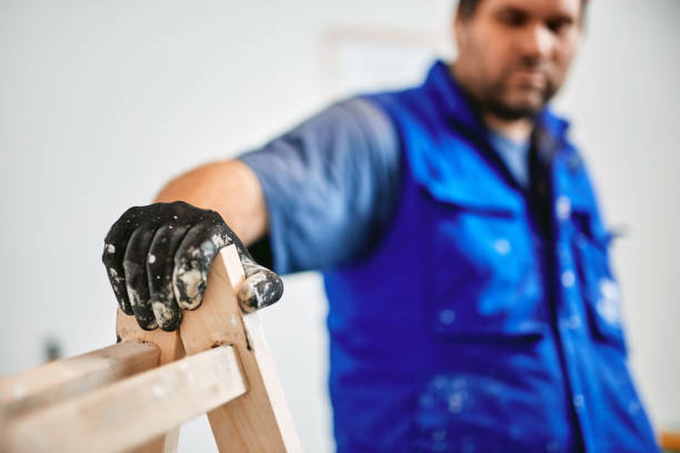 istock Worker painting walls inside the house - renovation fixes. 1162286616