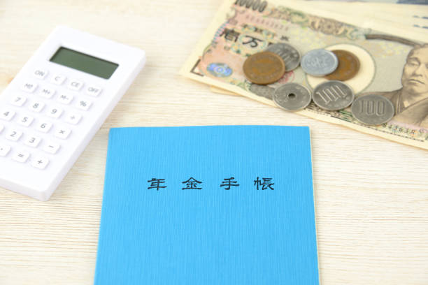 istock Japanese pension handbook and calculator with currency 1162286652