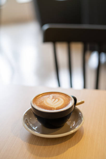 istock Delicious flat white coffee with coffee art on top of wooden table 1162287724